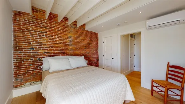 a bedroom with a bed and chair