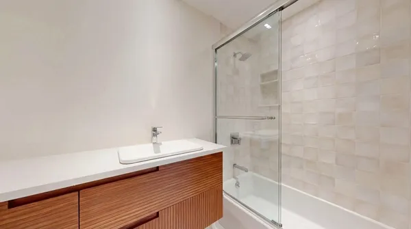 a bathroom with a sink a shower and a mirror