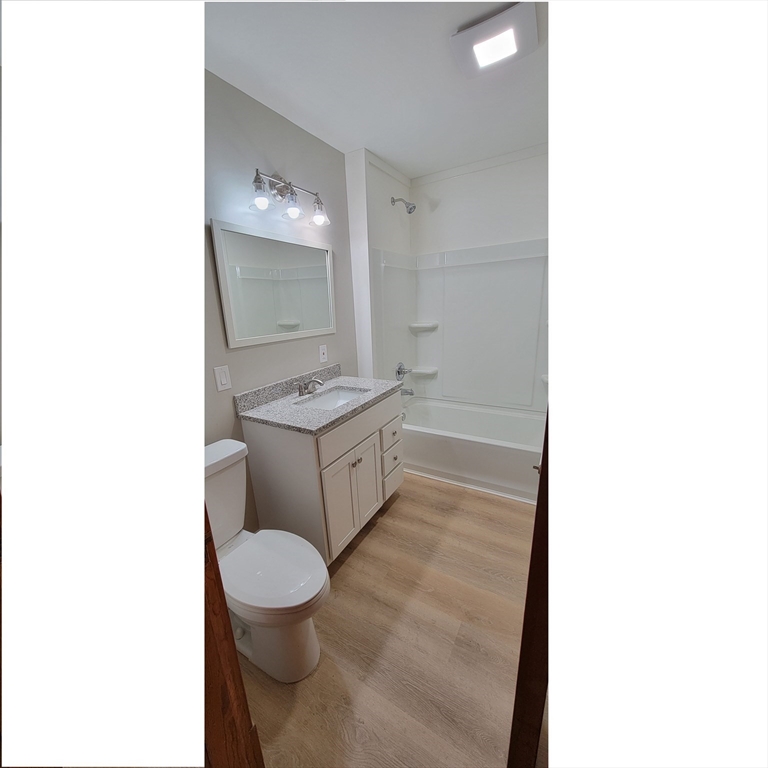 74 Melha Avenue Springfield, MA 01104 - Photo 16 of 16 a bathroom with a toilet a sink and mirror