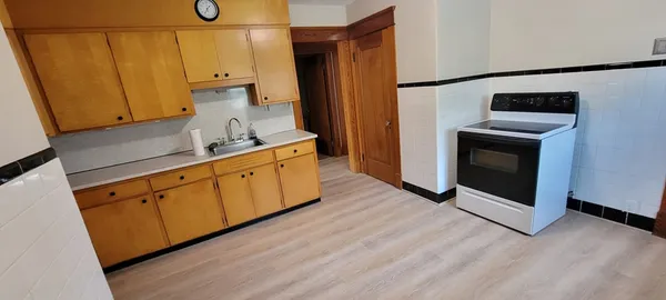 a kitchen with stainless steel appliances a stove a microwave and a refrigerator