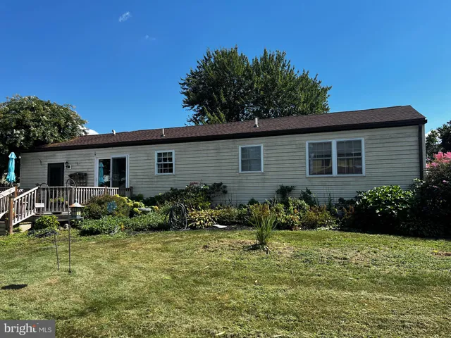 a kitchen with stainless steel appliances granite countertop a refrigerator a stove and a sink