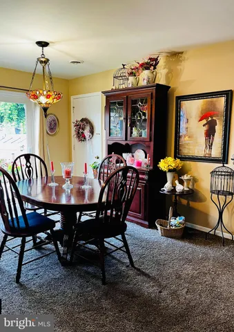 a view of a dining room with furniture and chandelier