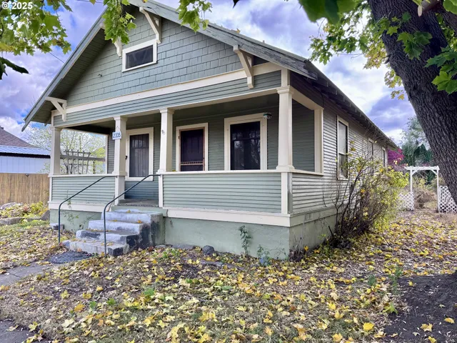 a view of a house with a yard and sitting area