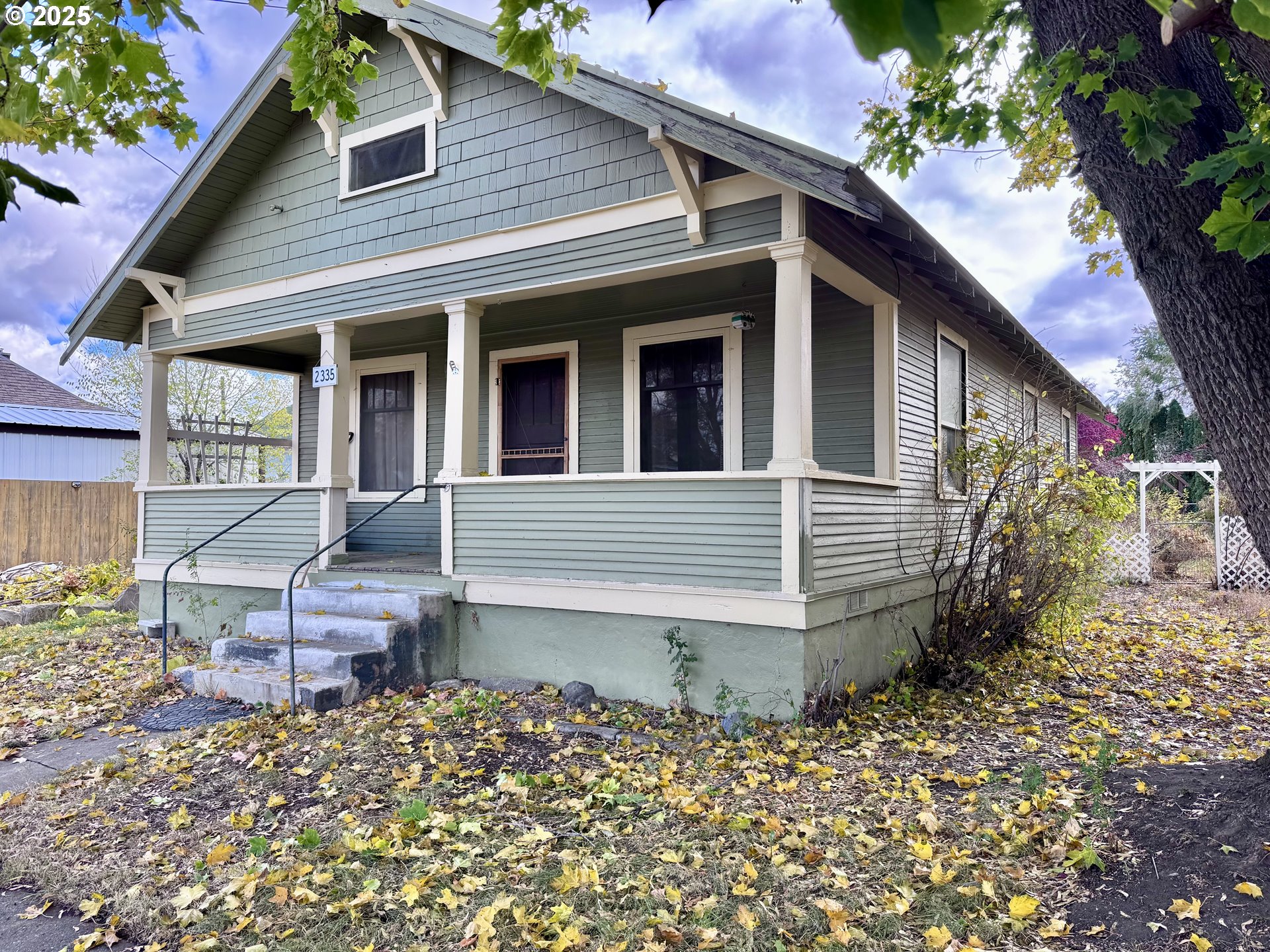 a view of a house with a yard and sitting area