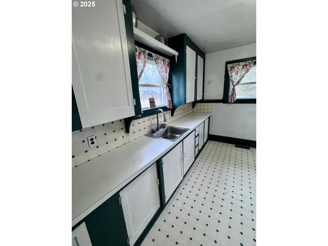 a bathroom with mirror sink and window