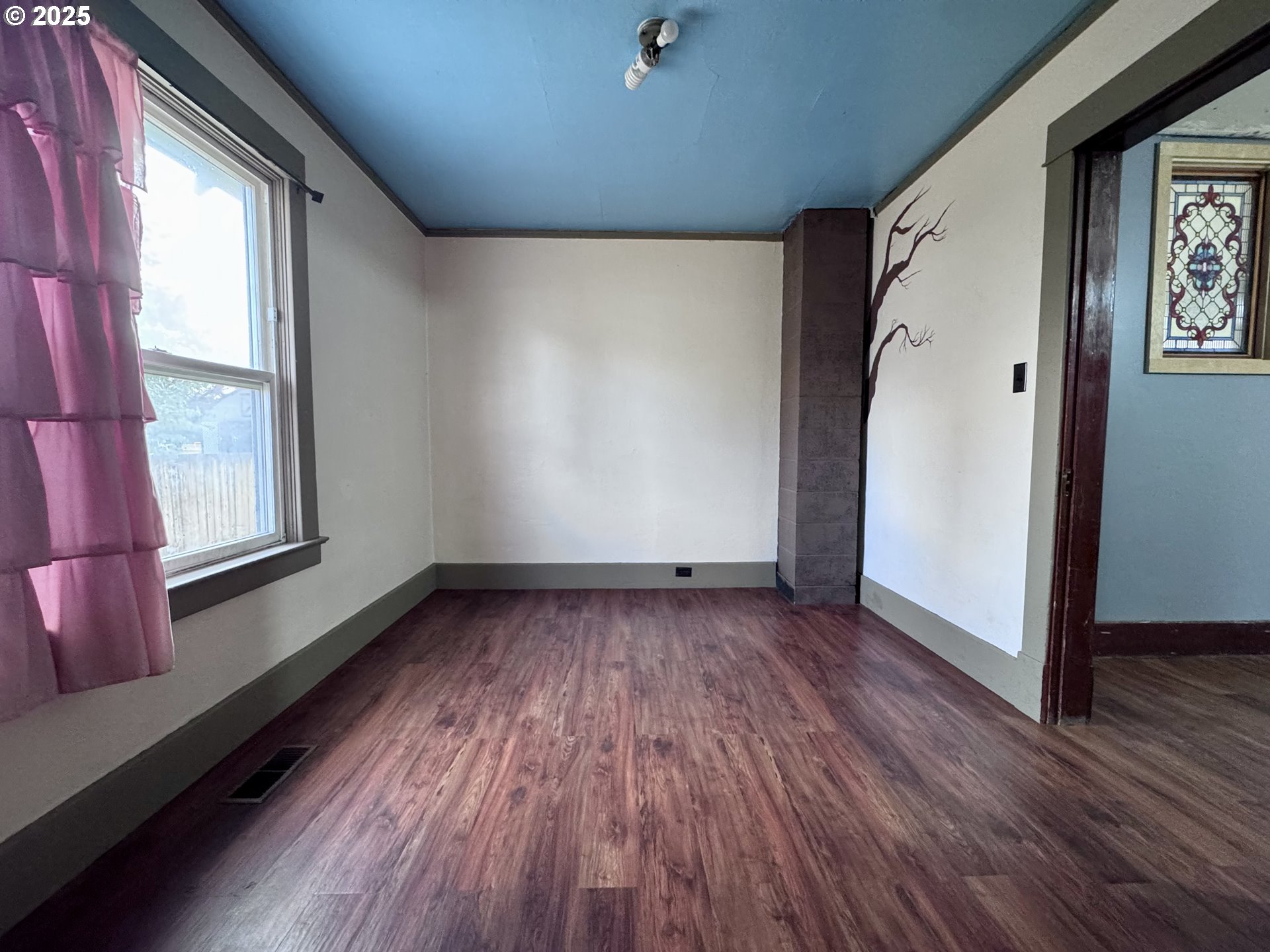2335 Grace Street Baker City, OR 97814 - Photo 5 of 19 an empty room with wooden floor and windows