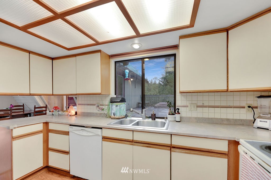15307 Baker Heights Road Mount Vernon, WA 98273 - Photo 11 of 37 a kitchen with sink a window and cabinets