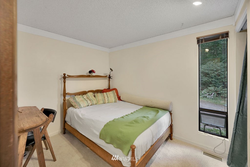 15307 Baker Heights Road Mount Vernon, WA 98273 - Photo 15 of 37 a bedroom with a bed and a window