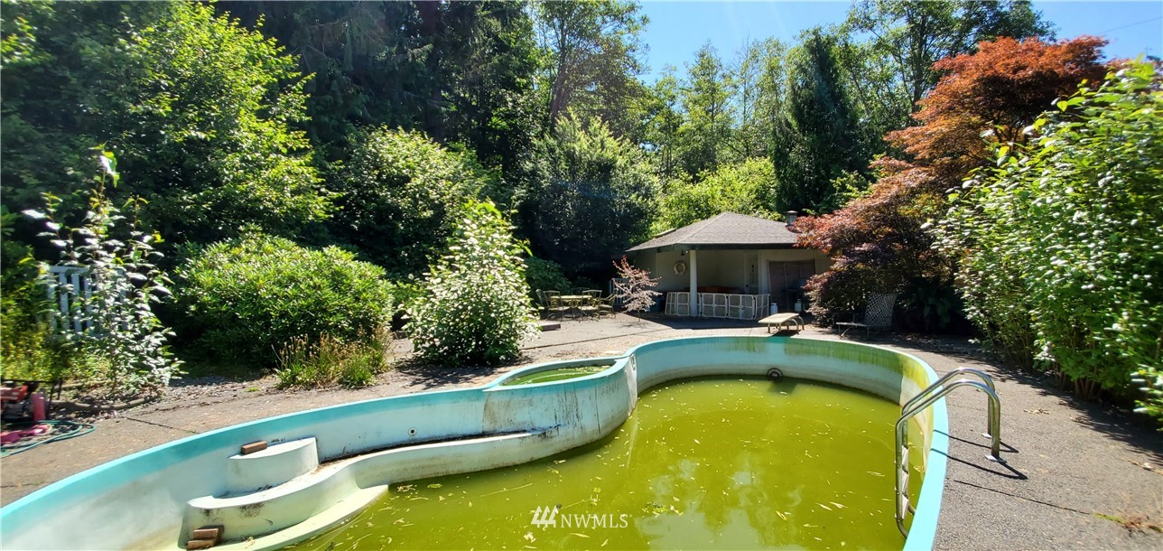 15307 Baker Heights Road Mount Vernon, WA 98273 - Photo 28 of 37 a view of a swimming pool with a yard