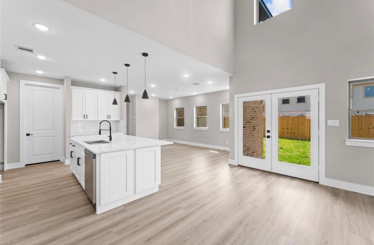 2606 Liguria Ln Spring Spring, TX 77388 - Photo 5 of 29 a large white kitchen with a large window a sink and stainless steel appliances