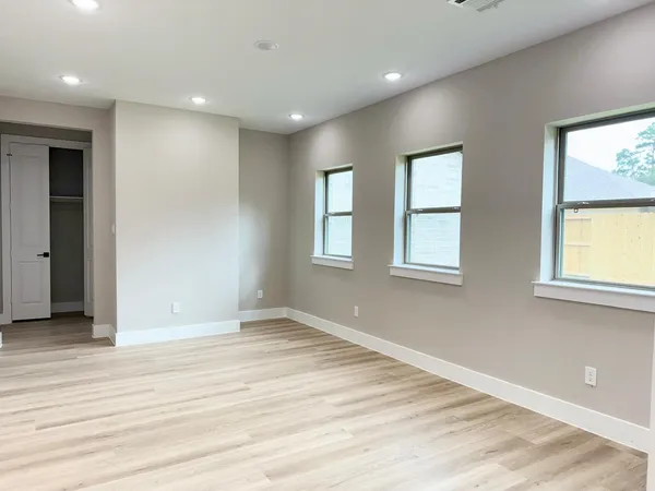 a view of walk in closet with empty racks