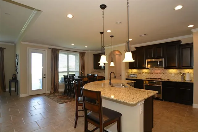 a open kitchen with a large window and cabinets