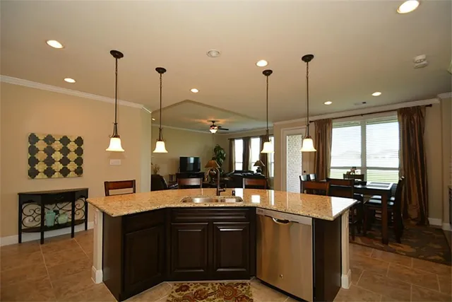 a dining hall with stainless steel appliances kitchen island a table and chairs