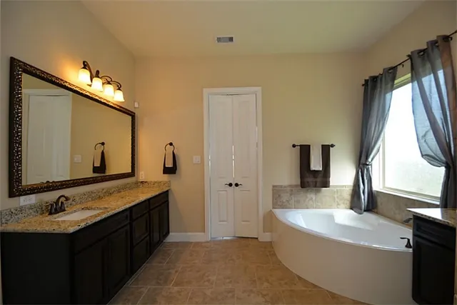 a view of walk in closet with clothes