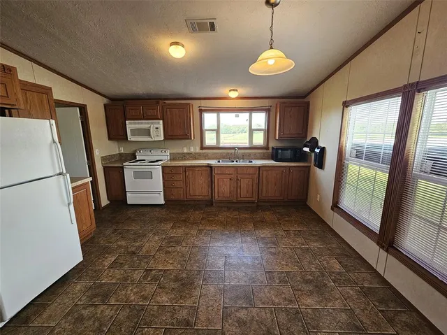 a kitchen with refrigerator and window
