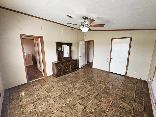 a large bedroom with a bed and a chandelier