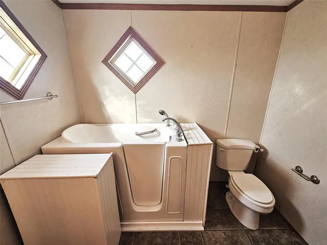 a white toilet sitting next to a bathroom sink