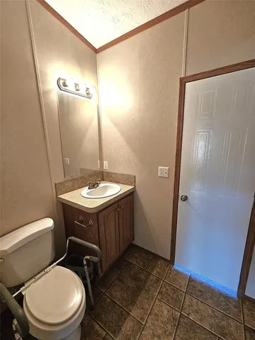 a bathroom with a sink a toilet a mirror and shower