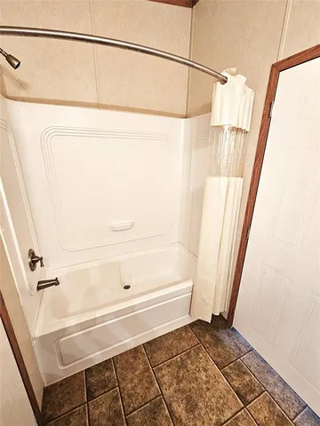 a bathroom with a shower and a window