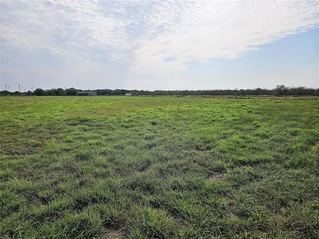 a view of a field with an ocean view