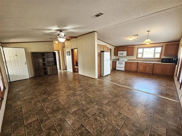 a view of a livingroom with furniture and a window
