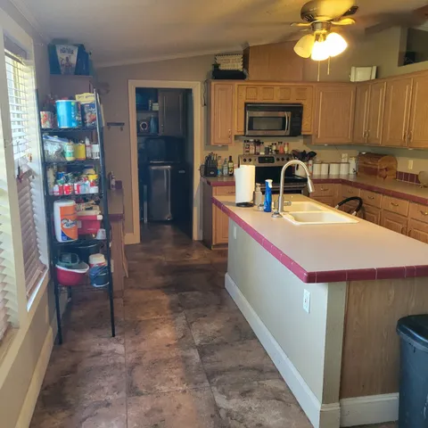 a dining room with furniture a chandelier and wooden floor