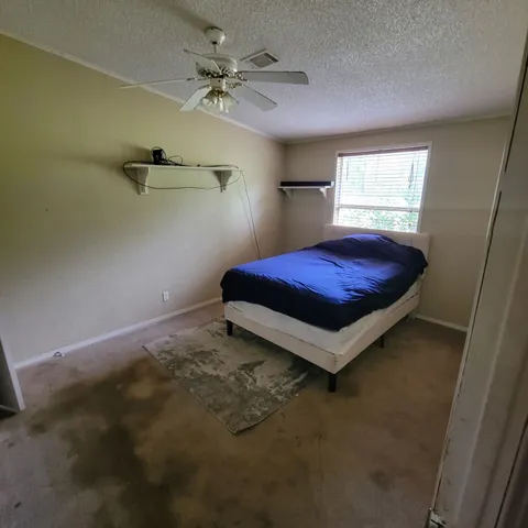 a view of a house with a backyard and a patio