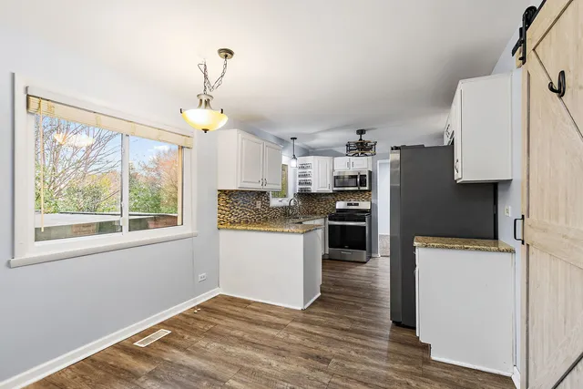 a kitchen with a refrigerator and a stove