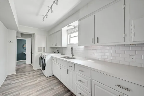 a kitchen with sink cabinets and window