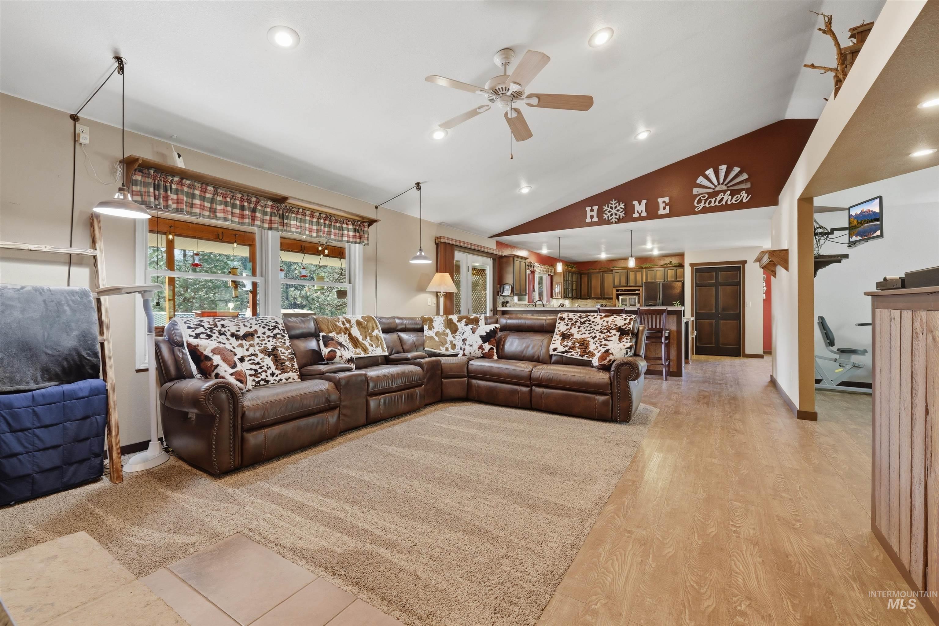 95 Johnson Creek Road Boise, ID 83716 - Photo 13 of 49 Living room with ceiling fan, recessed lighting, vaulted ceiling, and light wood-style floors