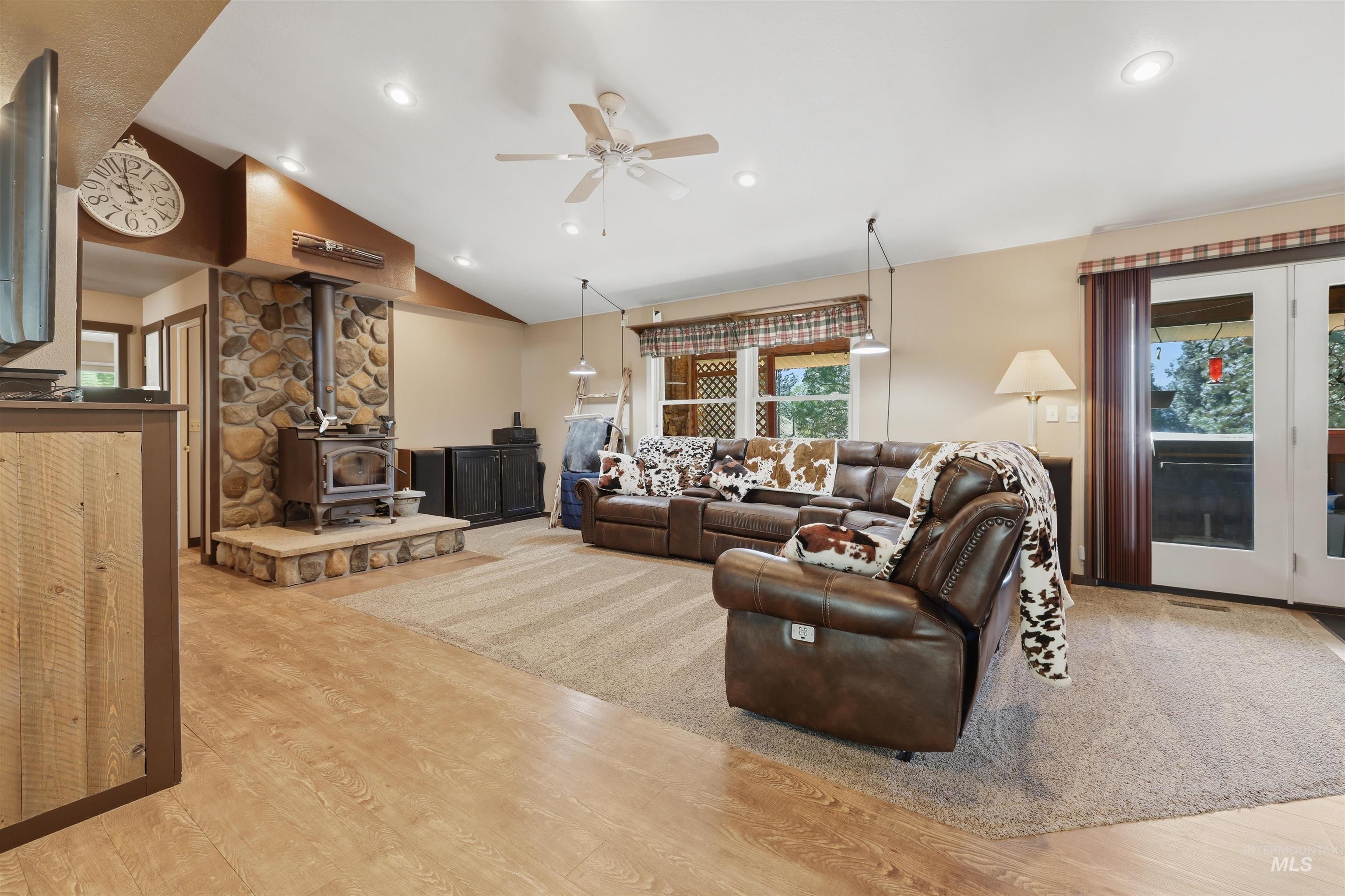 95 Johnson Creek Road Boise, ID 83716 - Photo 14 of 49 Living room with a wood stove, light wood finished floors, ceiling fan, vaulted ceiling, and recessed lighting