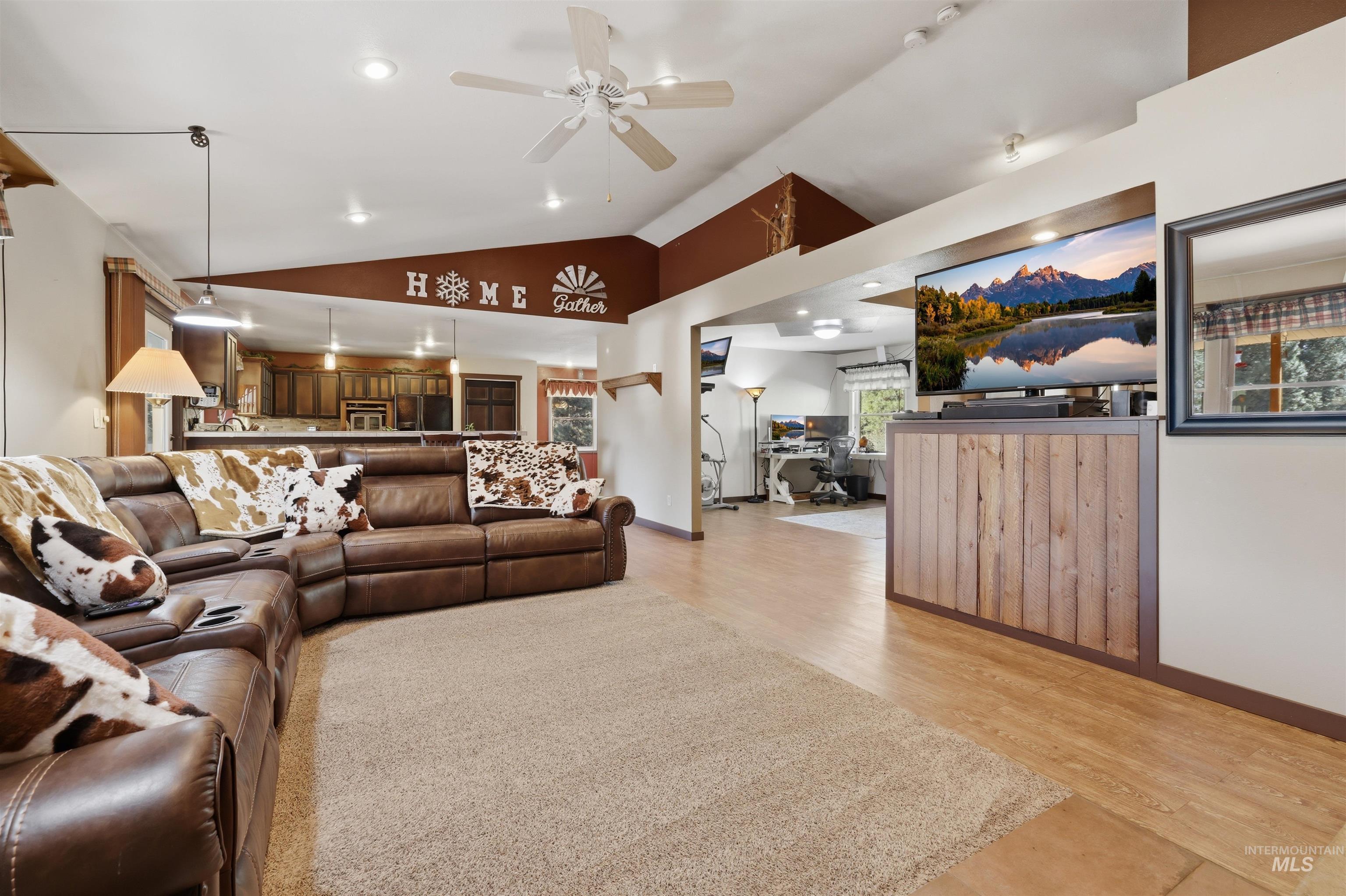95 Johnson Creek Road Boise, ID 83716 - Photo 15 of 49 Living area featuring ceiling fan, vaulted ceiling, light wood-type flooring, and recessed lighting