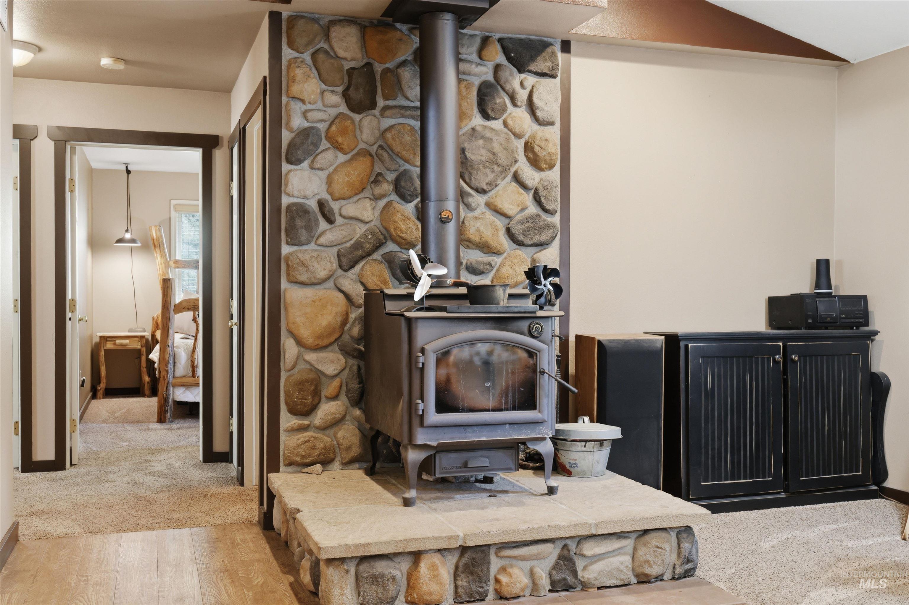 95 Johnson Creek Road Boise, ID 83716 - Photo 16 of 49 Detailed view of a wood stove and wood finished floors