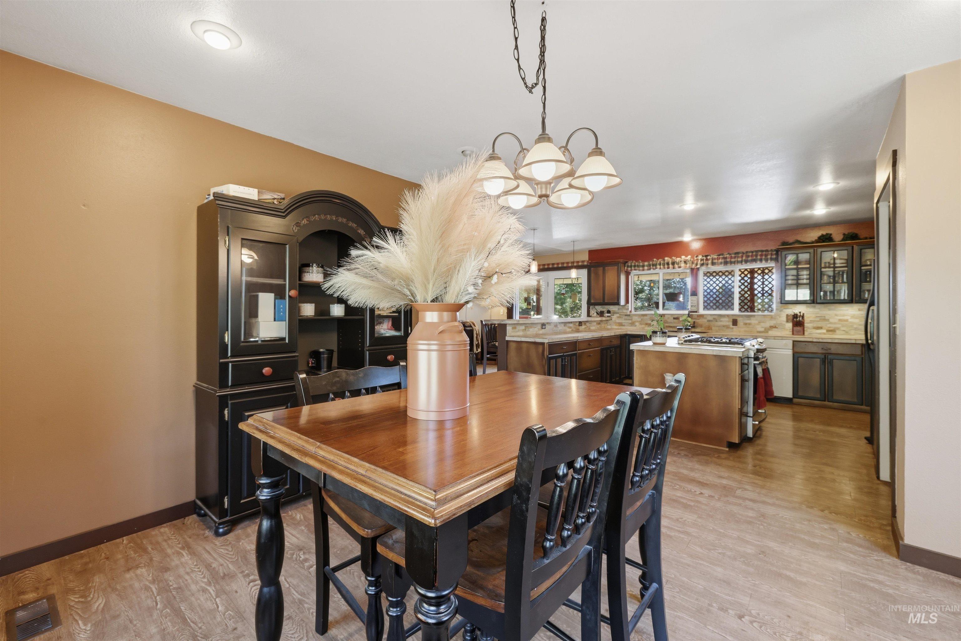 95 Johnson Creek Road Boise, ID 83716 - Photo 26 of 49 Dining room featuring hanging lights and light wood-style floors