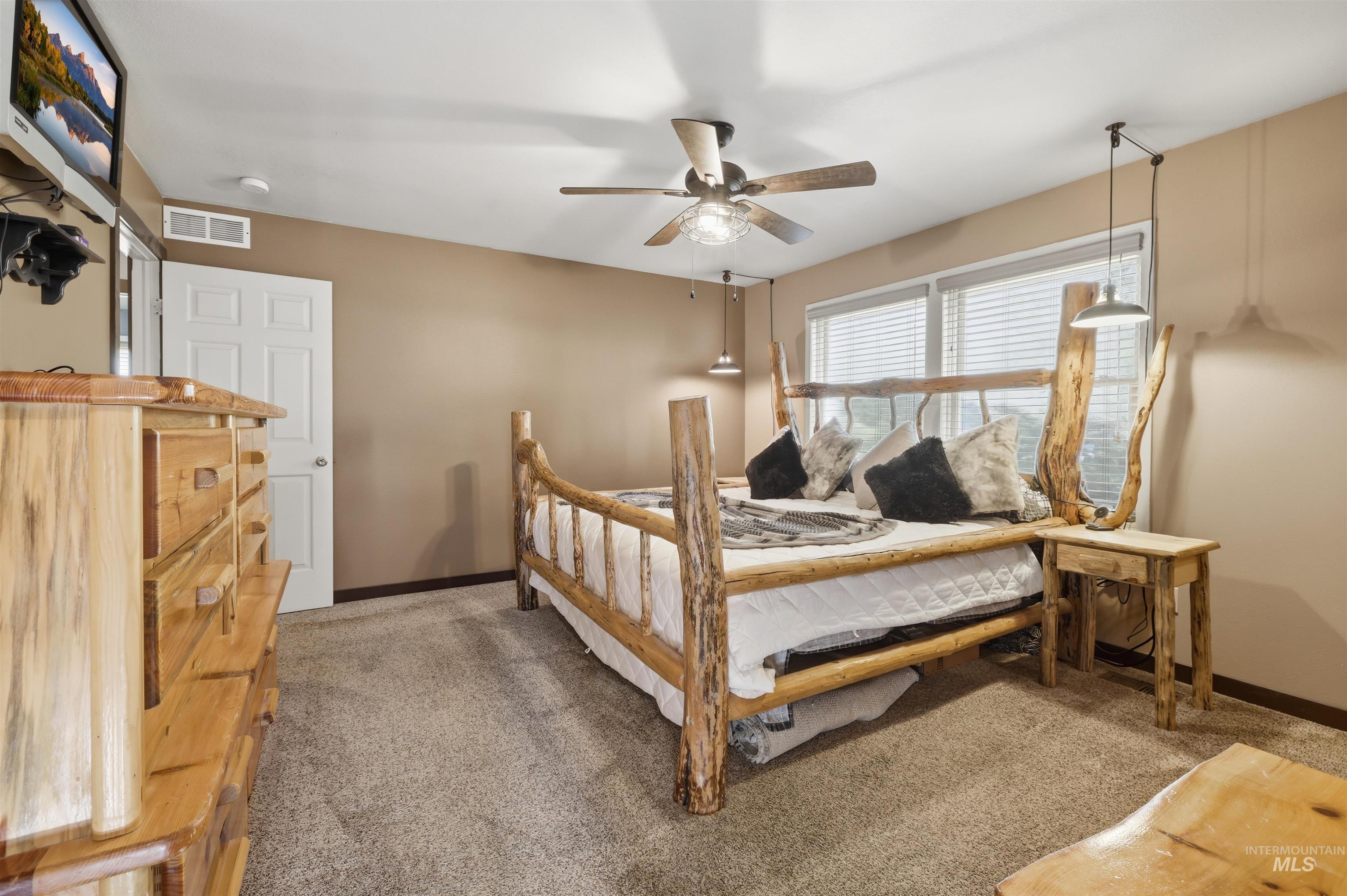 95 Johnson Creek Road Boise, ID 83716 - Photo 28 of 49 Bedroom featuring light colored carpet and ceiling fan
