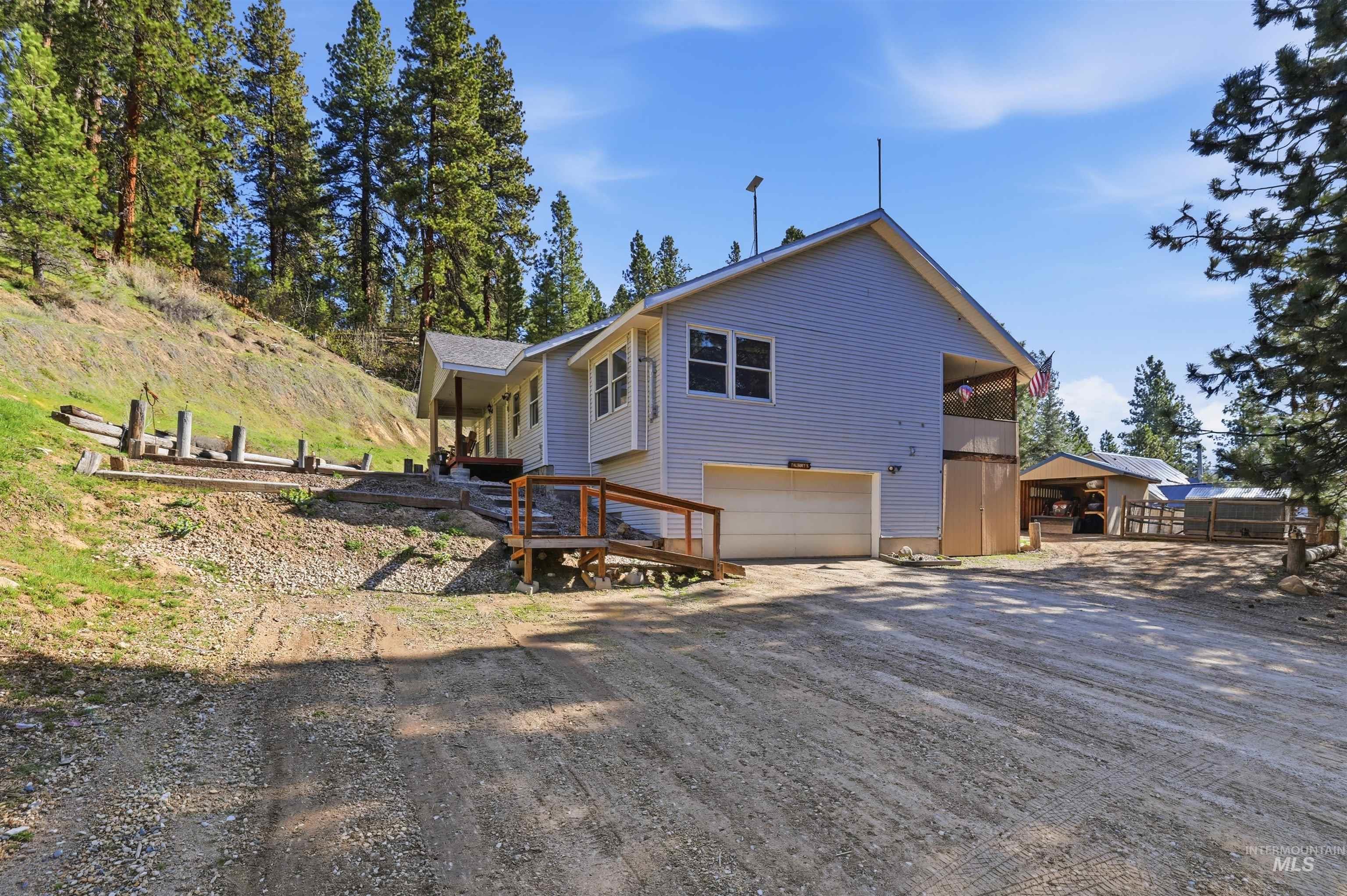 95 Johnson Creek Road Boise, ID 83716 - Photo 3 of 49 View of side of home featuring dirt driveway and a garage