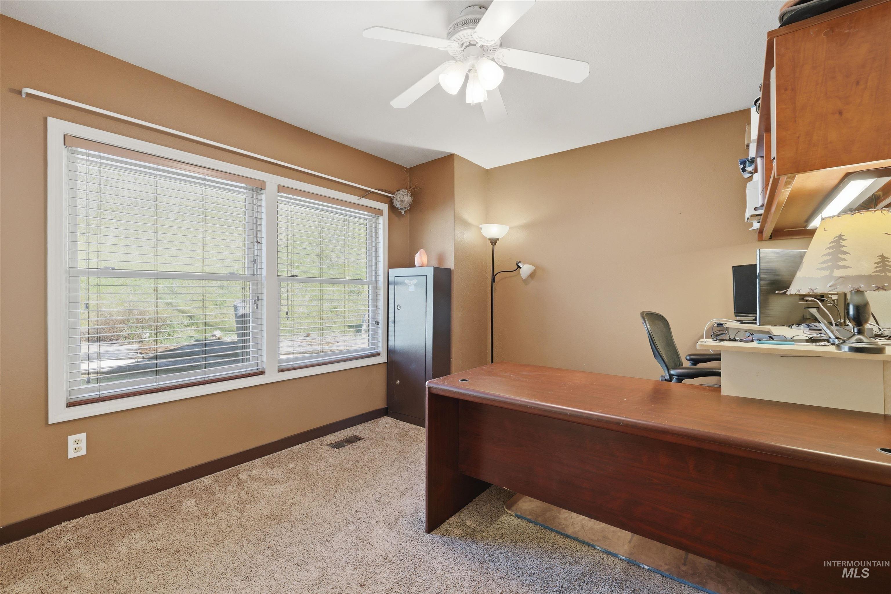 95 Johnson Creek Road Boise, ID 83716 - Photo 34 of 49 Office with ceiling fan and light carpet