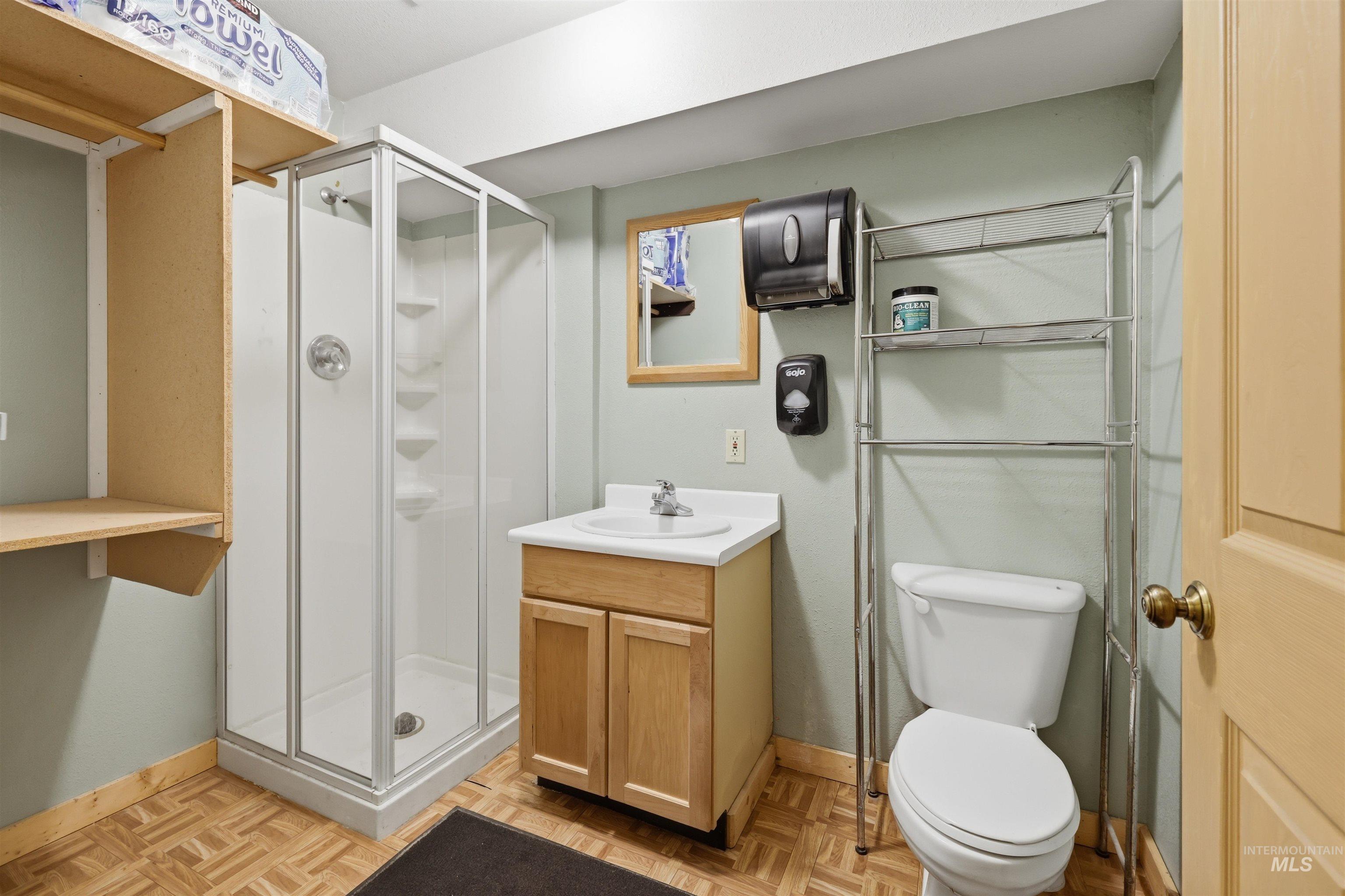 95 Johnson Creek Road Boise, ID 83716 - Photo 37 of 49 Bathroom with a shower stall, vanity, and parquet flooring