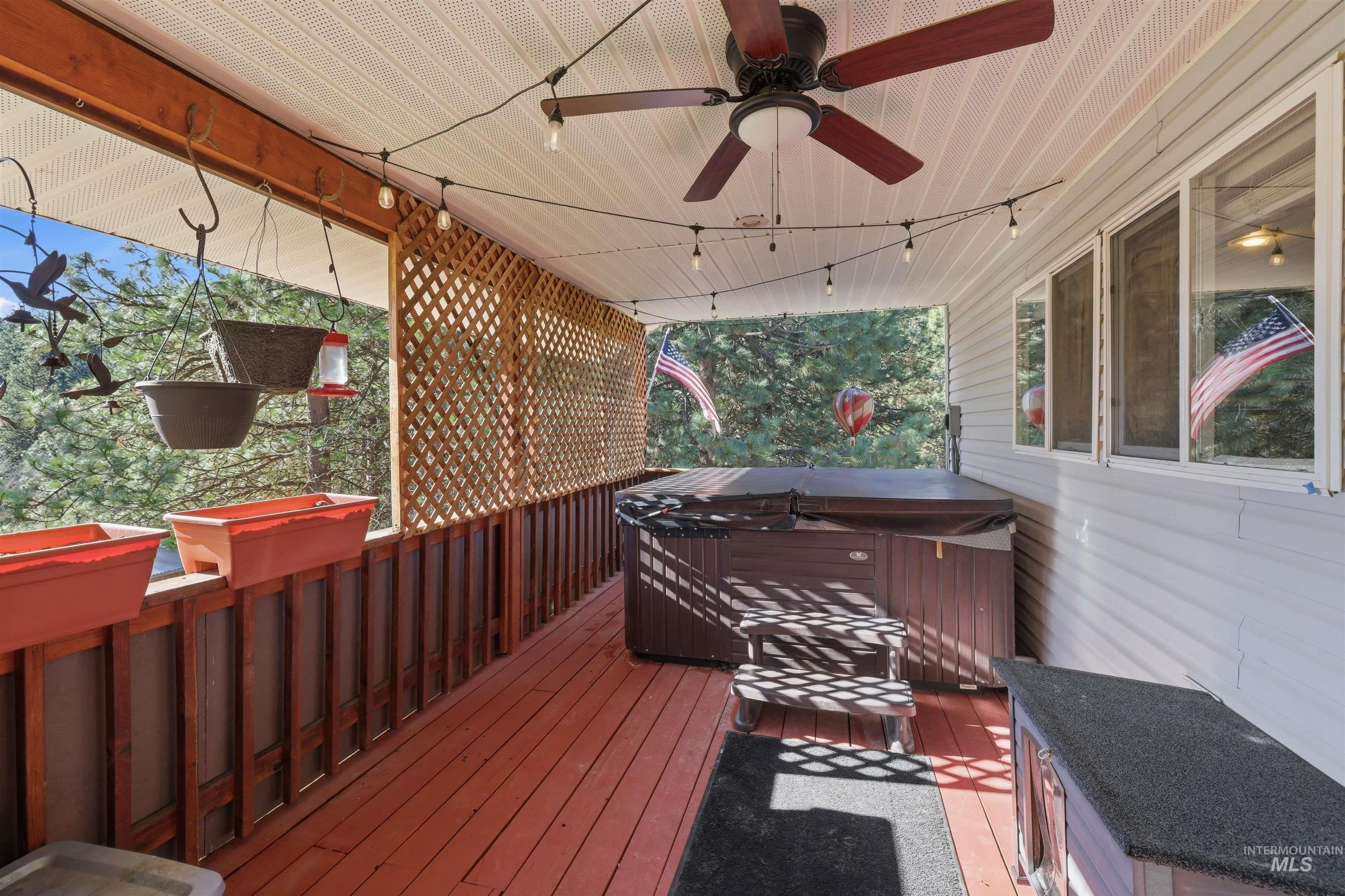 95 Johnson Creek Road Boise, ID 83716 - Photo 41 of 49 Wooden deck featuring a hot tub and ceiling fan