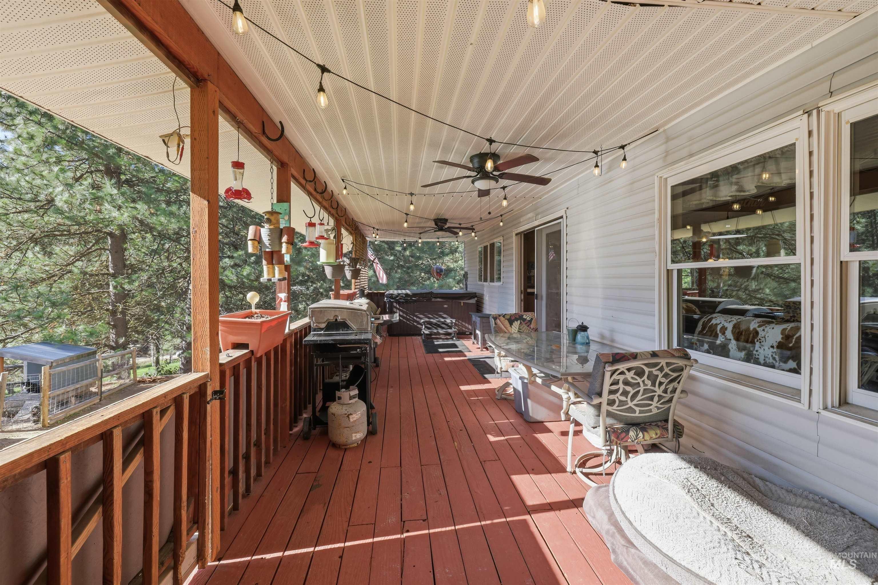 95 Johnson Creek Road Boise, ID 83716 - Photo 42 of 49 Deck featuring a hot tub and a ceiling fan