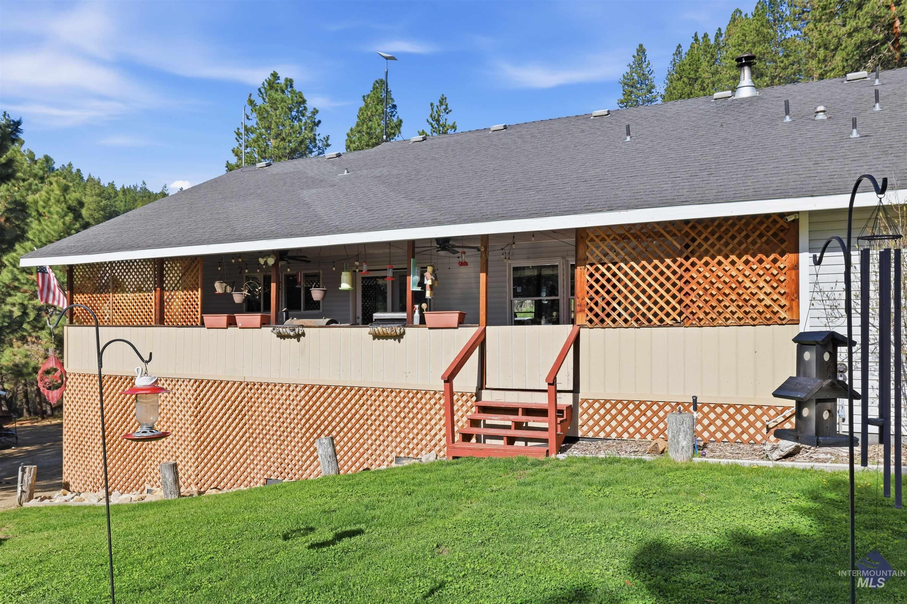 95 Johnson Creek Road Boise, ID 83716 - Photo 43 of 49 Rear view of property with roof with shingles and a lawn