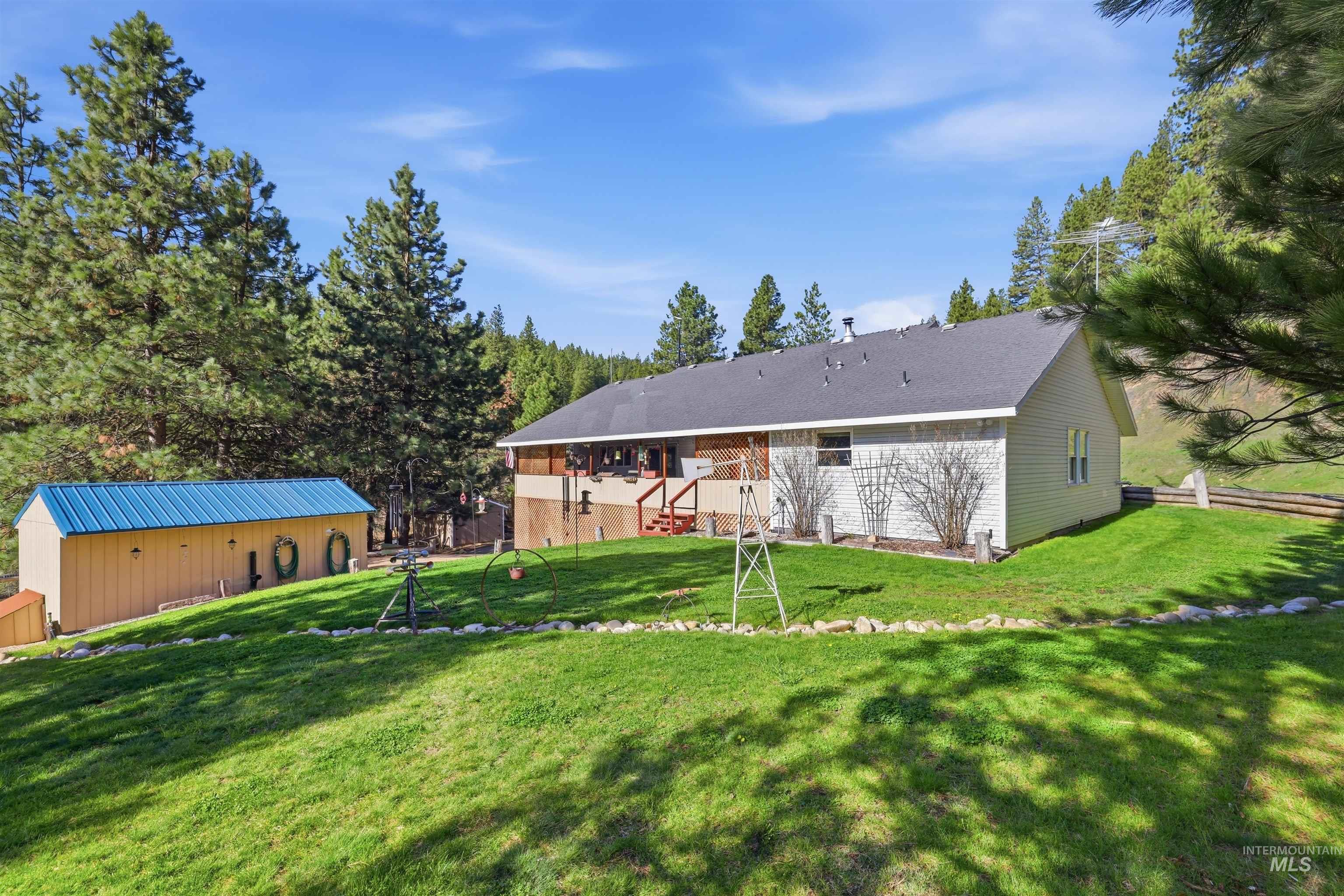 95 Johnson Creek Road Boise, ID 83716 - Photo 46 of 49 Back of property featuring an outdoor structure and a yard