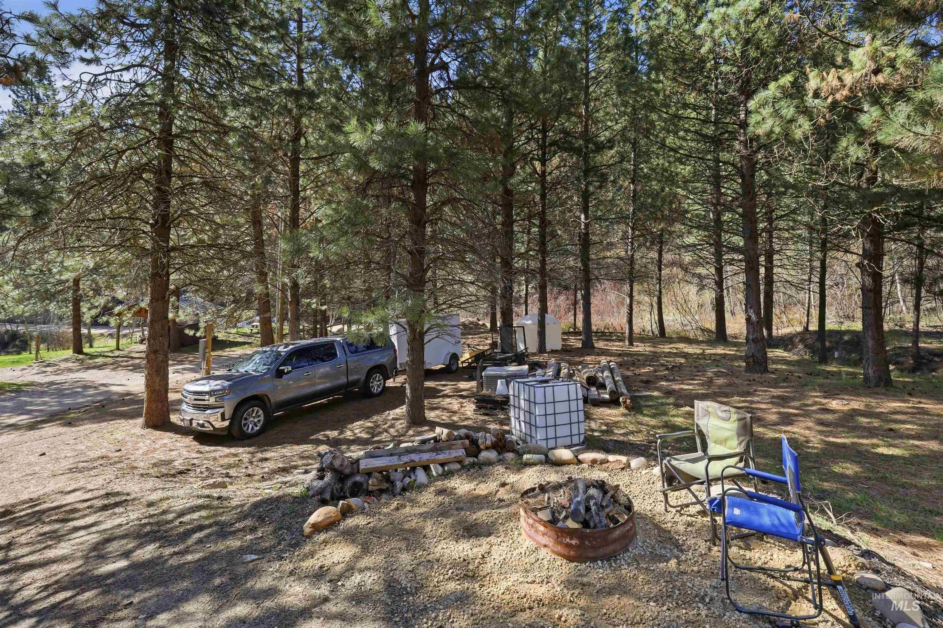 95 Johnson Creek Road Boise, ID 83716 - Photo 47 of 49 View of yard featuring a fire pit and view of scattered trees