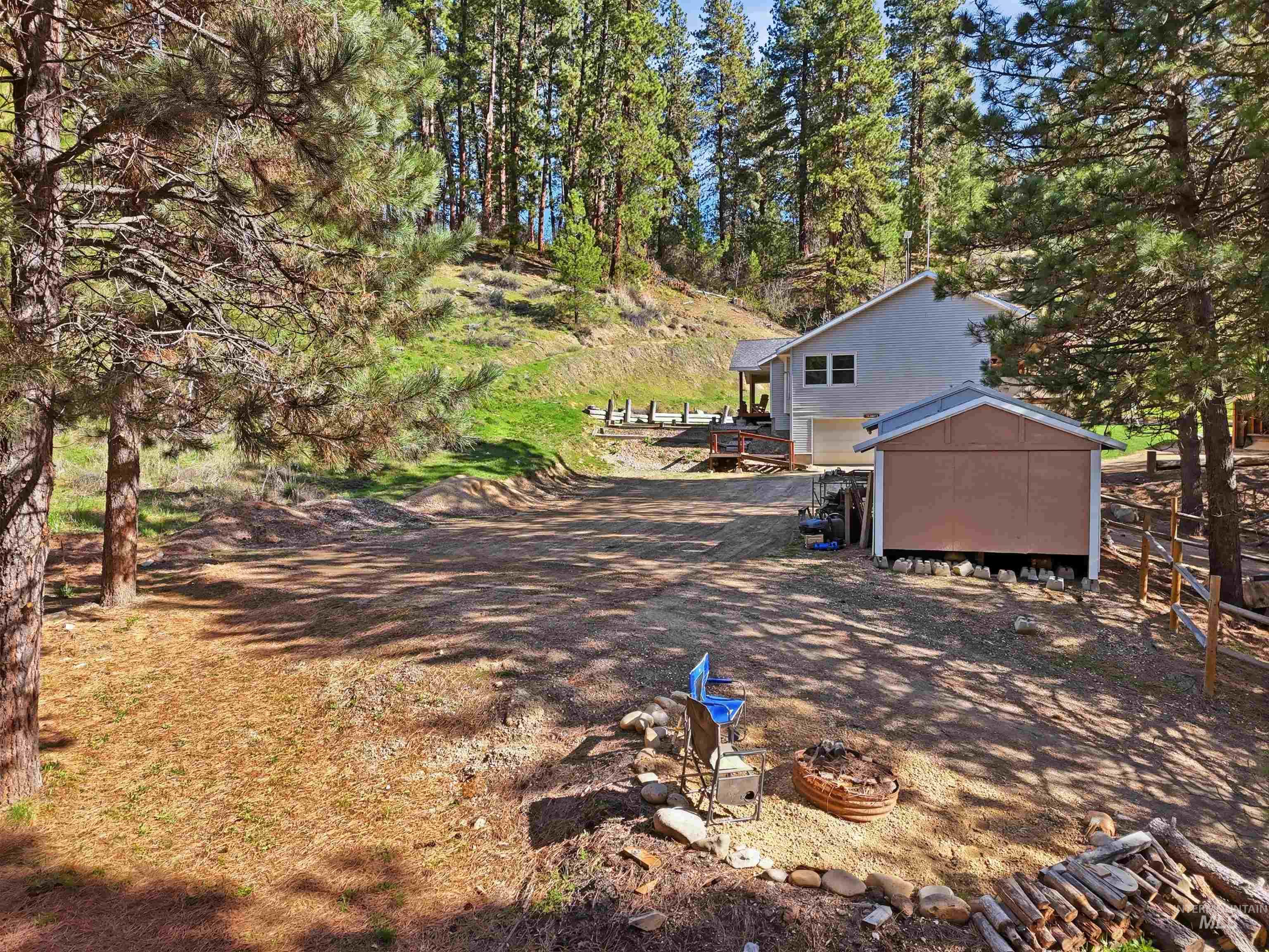 95 Johnson Creek Road Boise, ID 83716 - Photo 5 of 49 View of yard featuring a storage shed and view of scattered trees