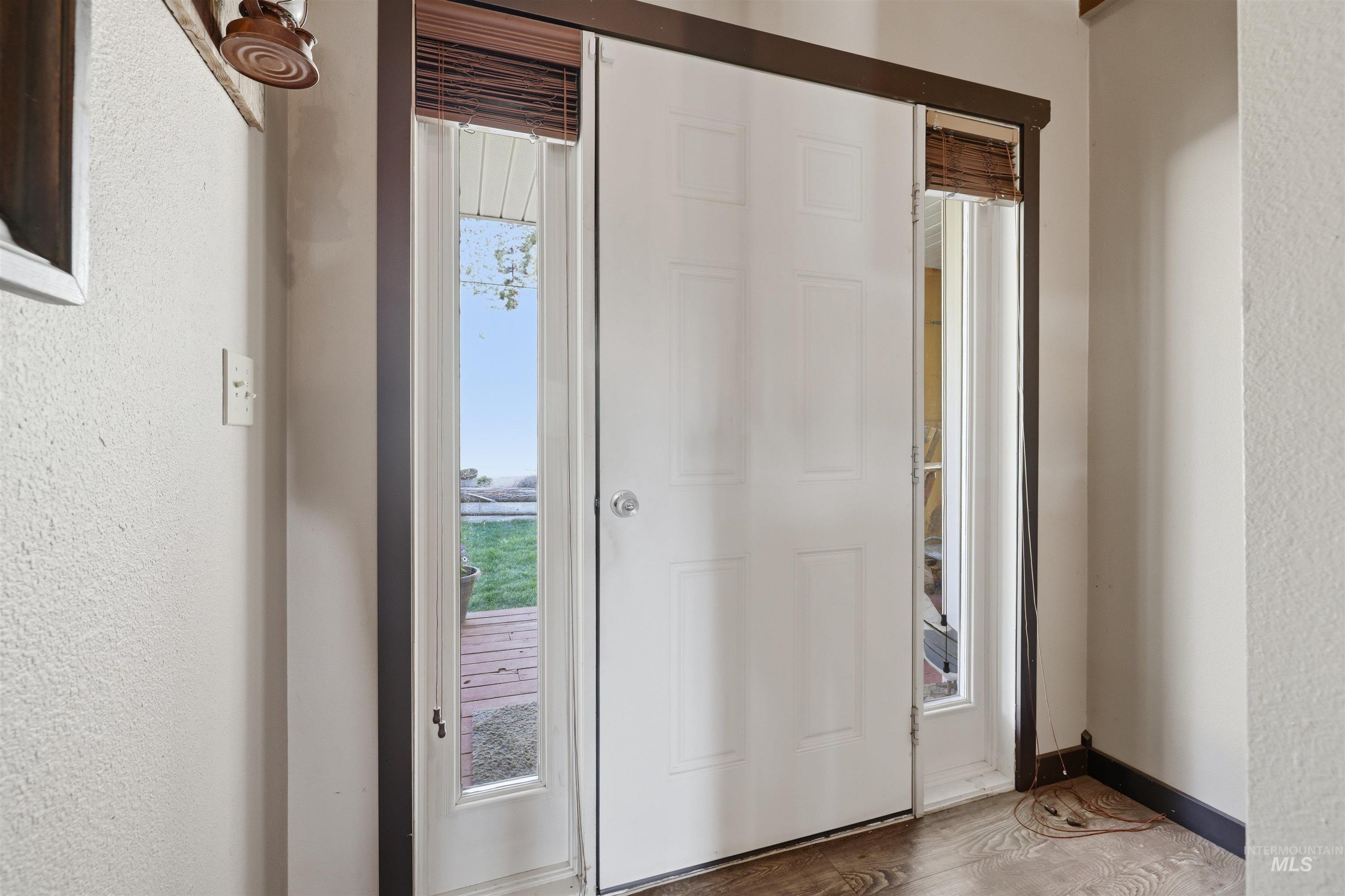95 Johnson Creek Road Boise, ID 83716 - Photo 9 of 49 Entryway with a textured wall and wood finished floors