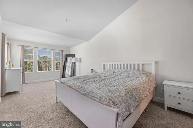 a bed sitting in a bedroom next to a window