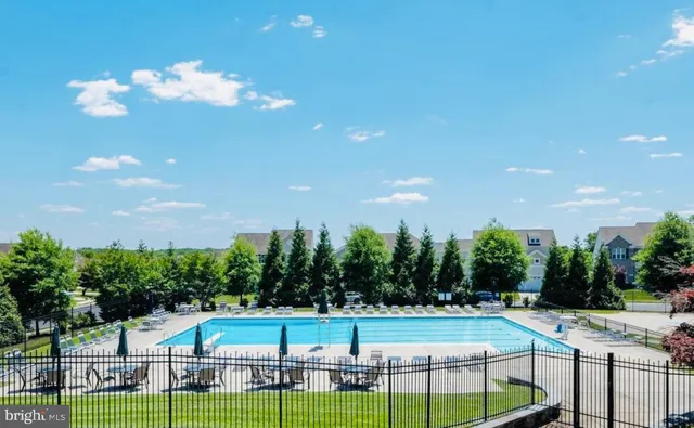 a view of a swimming pool with outdoor seating