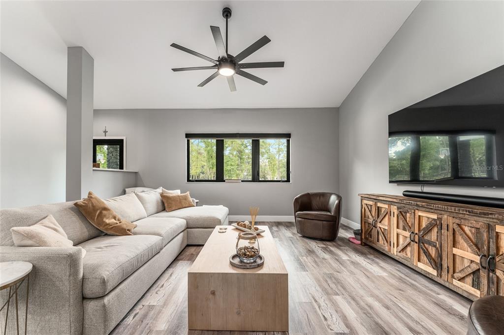 9 Middleground Road Ocala, FL 34482 - Photo 11 of 42 a living room with furniture and a flat screen tv