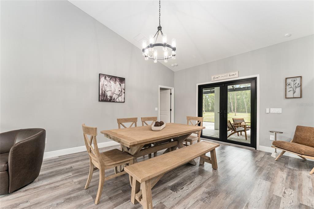 9 Middleground Road Ocala, FL 34482 - Photo 12 of 42 a dining room with wooden floor and a chandelier