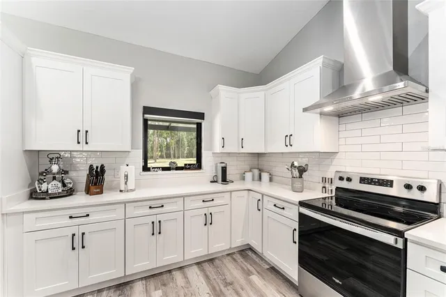 a kitchen with cabinets appliances a sink and a counter top